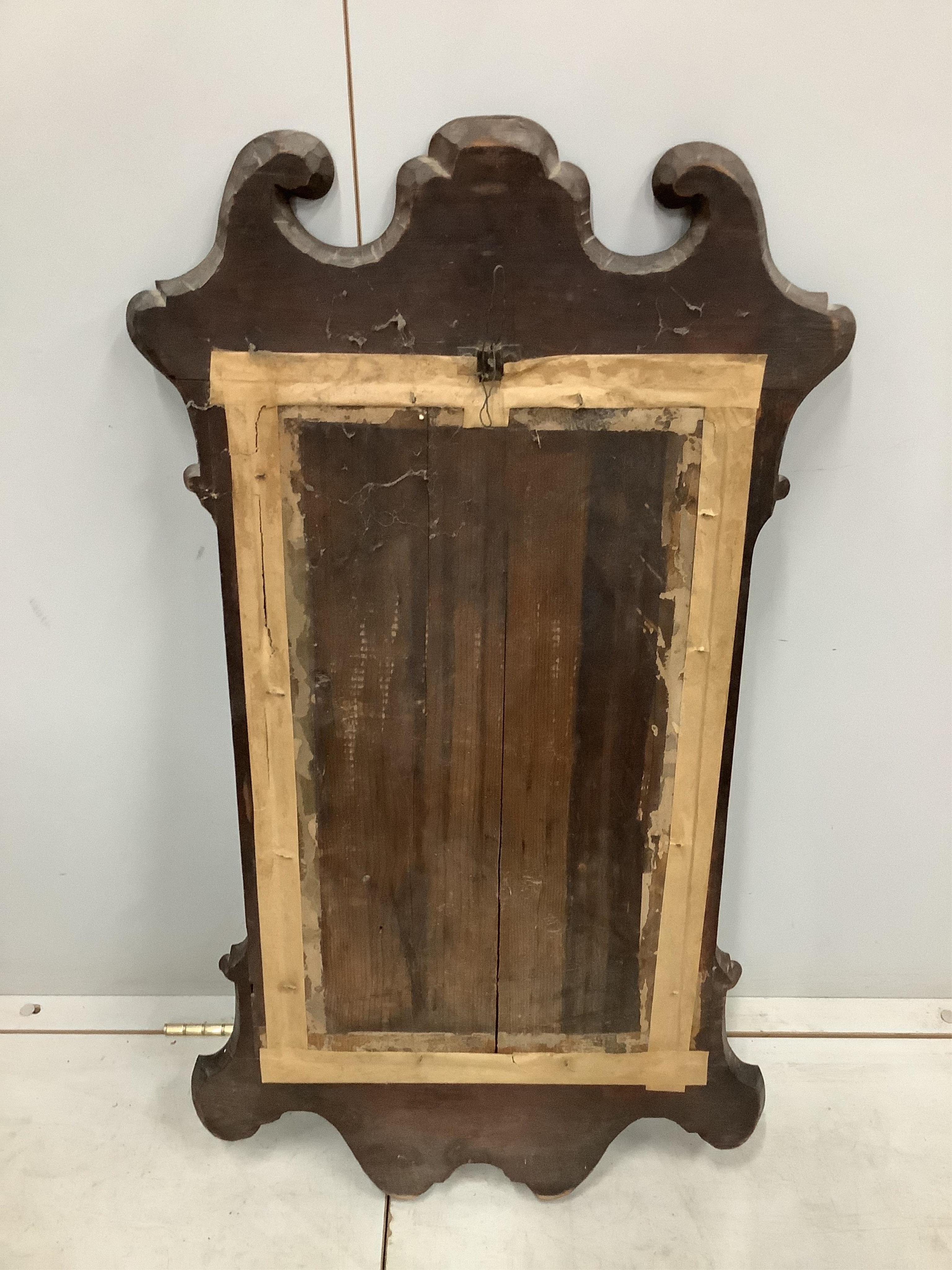 A George III style mahogany fret cut mirror, with a carved gilt slip, width 54cm, height 92cm. Condition - fair